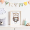 Stylish scandinavian newborn baby room with toys, teddy bear, accessories, ,cloud,colorful cotton flags and natural basket. Modern interior with mock up photo or poster frame. Real photo. Template.